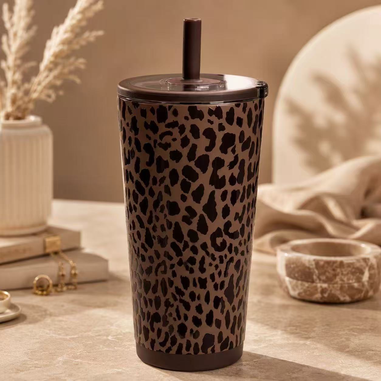 Leopard-pattern tumbler with a brown lid and straw