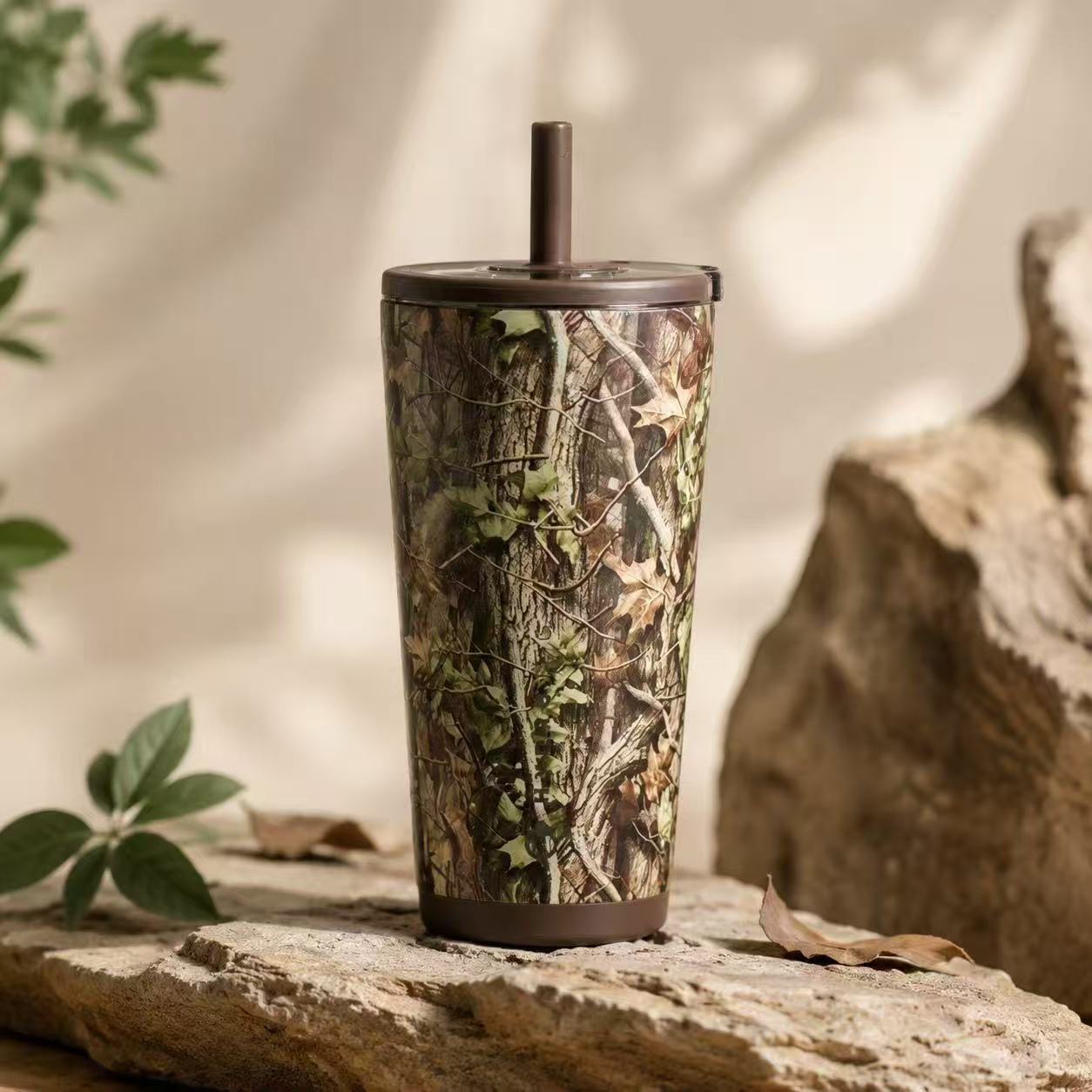 Woodland camouflage tumbler with a brown lid and straw
